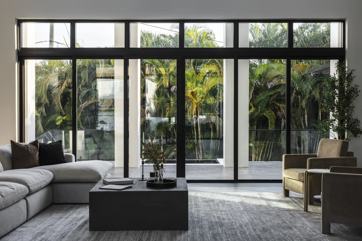 Living room seating facing tall glazed doors and the planted outdoor space